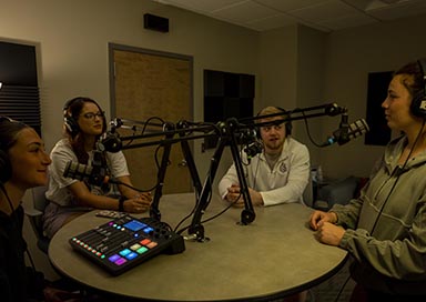 Four students doing a podcast
