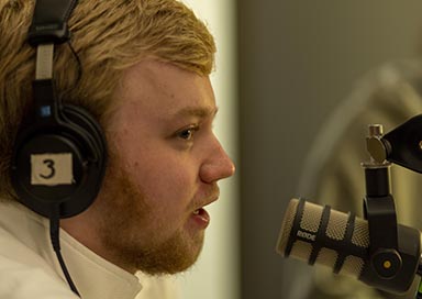 Male student doing a podcast