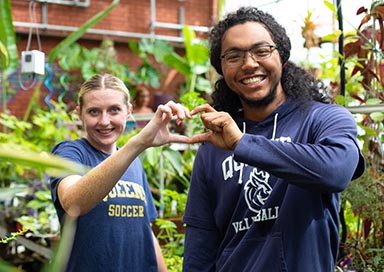 Two students in greenhouse