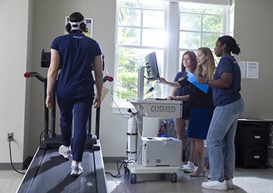 Professor and students performing stress test