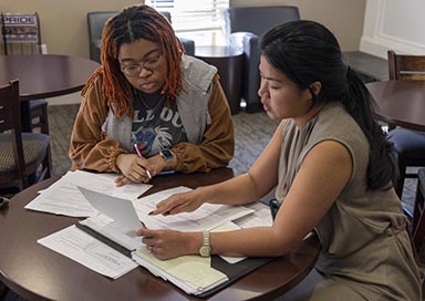 Students working on paperwork in coffeeshop