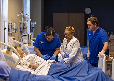 Nursing students working on dummy