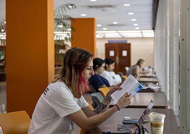 Student reading a book in library