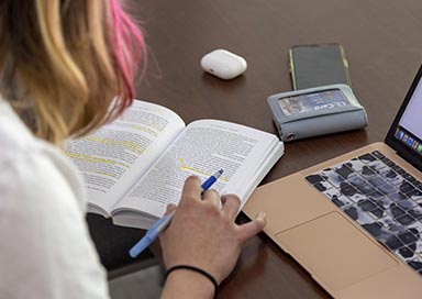 Student making notes in book