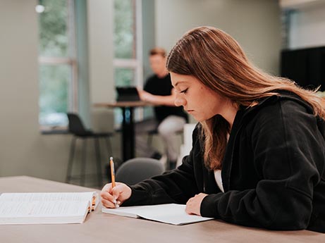 Student writing in journal