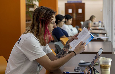Student reading in library