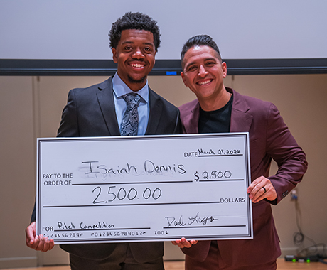 Isaiah Dennis and Oscar Barzuna Hidalgo with the big check