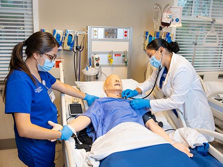 RN and Doctor working on patient in sim lab