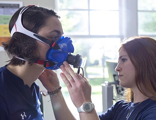 Student putting oxygen mask on student