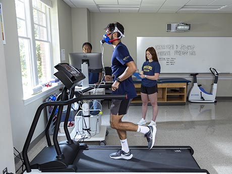 Students working with patient on treadmill