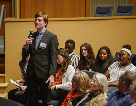 Student asking question during panel