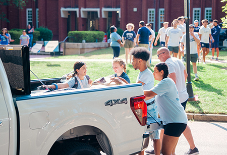 Students and parents moving stuff into res halls