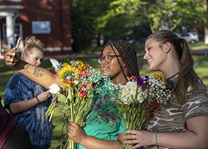 Students taking selfie with flowers