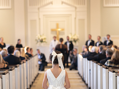 Little girl walking down aisle at Belk Chapel