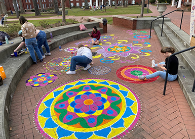 Students doing art with sidewalk chalk