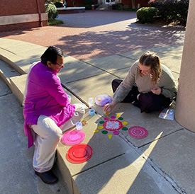 Student doing sand art at Diwali event