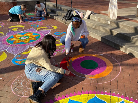 Students making designs on bricks for Diwali