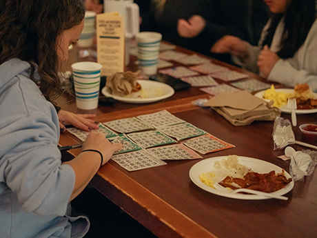 Students playing bingo and eating breakfast