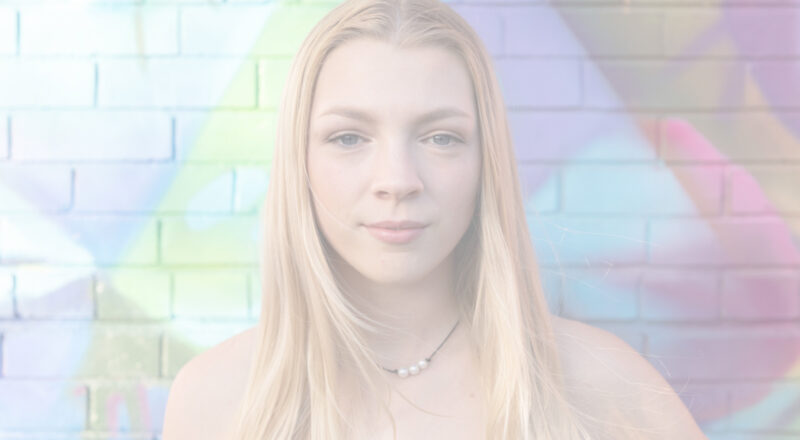 Student in front of colorful wall