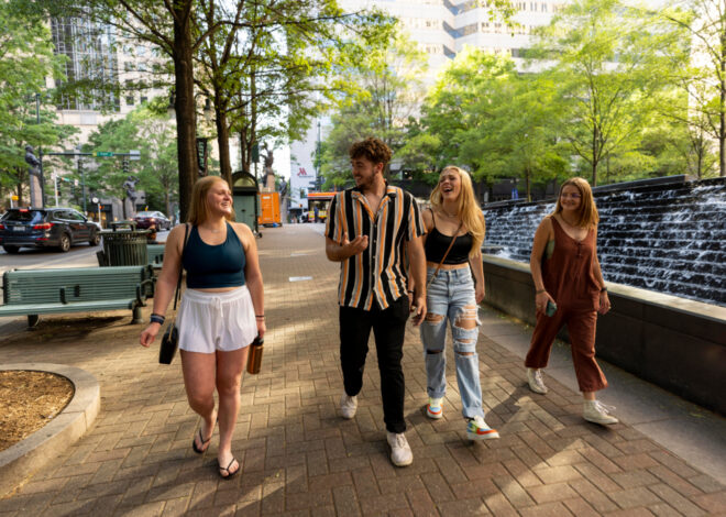 Students laughing while walking down the street in Uptown