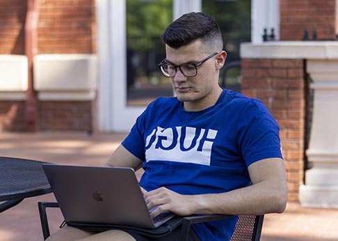 Male student working on laptop