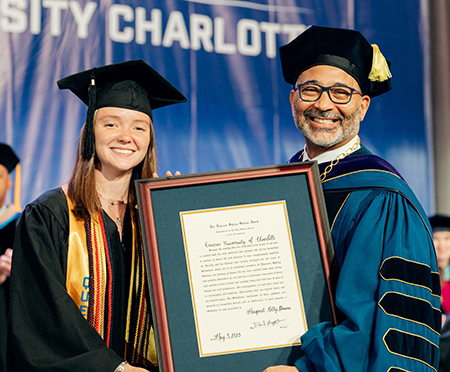Maggie Dineen accepting award from President Lugo