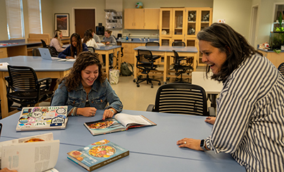 Shawn Bowers Buxton and student reading recipes