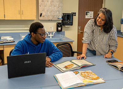 Shawn Bowers Buxton and student reading recipes