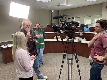 Dr. Renfroe and Dr. Cornelius discussing scene with student
