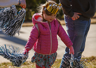 Little girl with pompoms at festivities