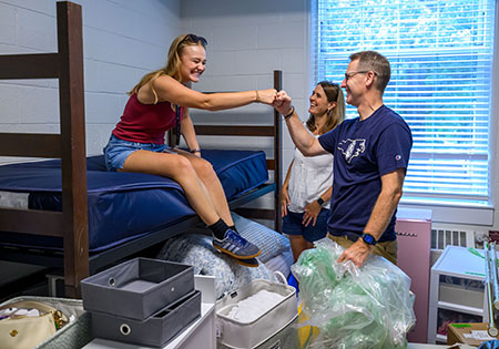 Adrian, Julie, and Lydia Bird in Elon dorm room