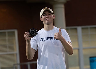 Oliver Pili holding a camera